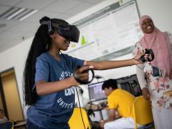 Annie helps a student in the Coppin Virtual Reality Lab