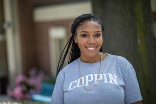 A student wearing a Coppin shirt on the University campus