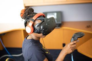 A student in a Virtual Reality headset